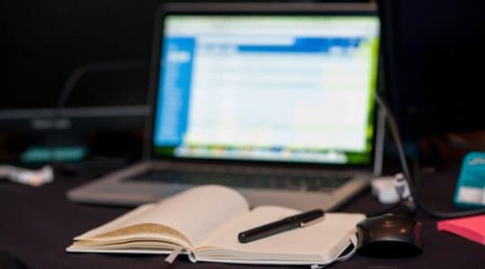 Image of computer and notebook for server-to-server tracking education